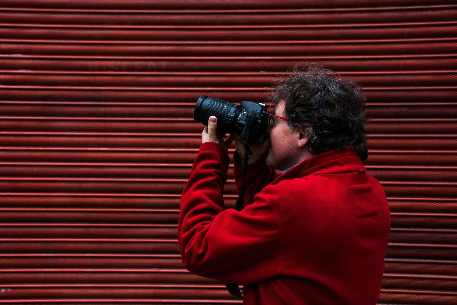 man using black DSLR camera