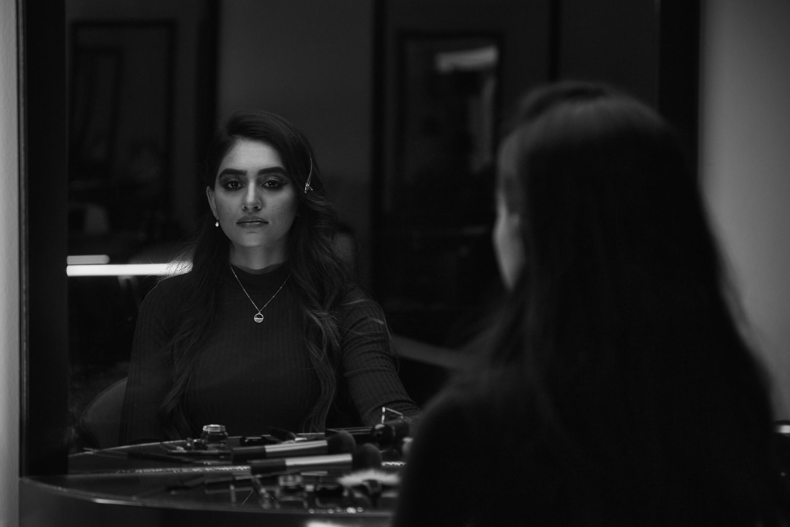 woman in black jacket sitting beside woman in black jacket